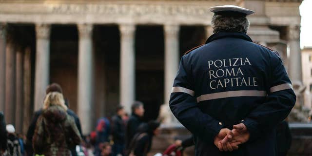 An Italian municipal policeman stands in front of Rome's Pantheon in Rome, Monday, Jan. 5, 2015. Italian government has sent in inspectors to Rome after about 85 percent of the officer called in sick on New Year's Eve. (AP Photo/Andrew Medichini)