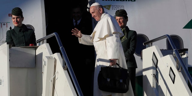 Pope Francis boards an airplane at Rome's Fiumicino international airport, on his way to Malmo, Sweden, Monday, Oct. 31, 2016. Pope Francis is heading to secular Sweden to mark the 500th anniversary of the Protestant Reformation. (AP Photo/Alessandra Tarantino)