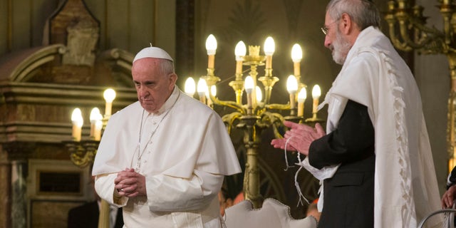 Pope Francis flanked by Rabbi Riccardo Di Segni, right, during his visit to the Great Synagogue of Rome, Sunday, Jan. 17, 2016. Pope Francis made his first visit to a synagogue as pope Sunday, greeting Rome's Jewish community in their house of worship as his two predecessors did in a show interfaith friendship at a time of religiously-inspired violence around the globe. (AP Photo/Alessandra Tarantino)