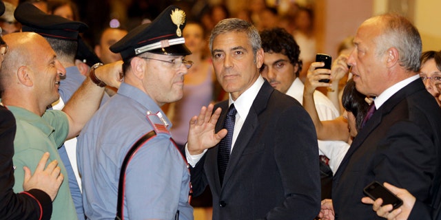 July 16: U.S. actor George Clooney leaves a tribunal in Milan, Italy.  Clooney appeared in court as a witness in a fraud trial against defendants charged with co opting his name for a line of clothing. (AP)