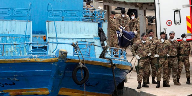 Oct. 6: Italian soldiers carry body bags at the Lampedusa island, Italy.