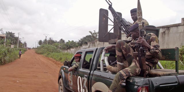 Aug. 6, 2012: Ivory Coast troops patrol around the Cocody area in the city of Abidjan, Ivory Coast. An Ivory Coast military official says seven soldiers have been killed in another attack by gunmen on a military camp in the commercial capital, Abidjan.