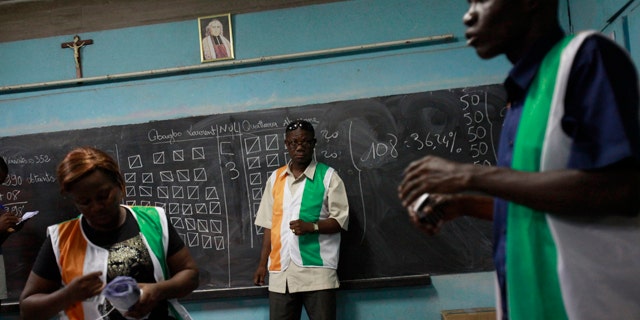 Nov. 28, 2010: Poll workers finish counting votes at a polling station in the Treichville neighborhood of Abidjan, Ivory Coast.