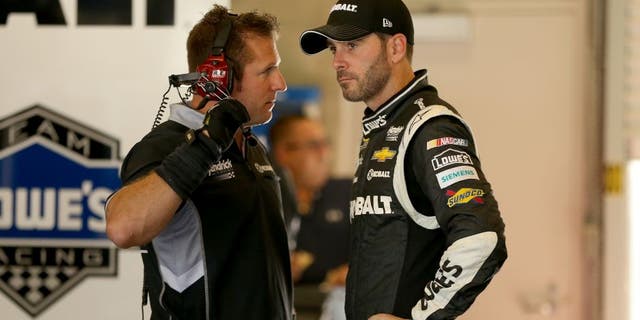 INDIANAPOLIS, IN - JULY 24: Jimmie Johnson, driver of the #48 Kobalt Tools Chevrolet, stands in the garage during practice for the NASCAR Sprint Cup Series Crown Royal Presents the Jeff Kyle 400 at the Brickyard at Indianapolis Motorspeedway on July 24, 2015 in Indianapolis, Indiana. (Photo by Andy Lyons/Getty Images)