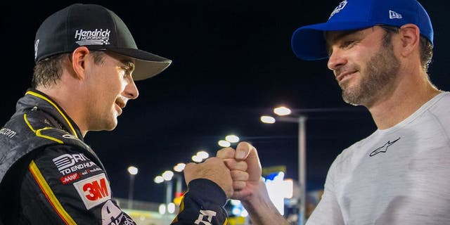 Nov 20, 2015; Homestead, FL, USA; NASCAR Sprint Cup Series driver Jeff Gordon (left) fist bumps teammate Jimmie Johnson following qualifying for the Ford Ecoboost 400 at Homestead-Miami Speedway. Mandatory Credit: Mark J. Rebilas-USA TODAY Sports