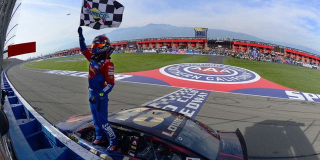 FONTANA, CA - MARCH 20: Jimmie Johnson, driver of the #48 Lowe's / Superman Chevrolet, celebrates after taking the checkered flag during the NASCAR Sprint Cup Series Auto Club 400 at Auto Club Speedway on March 20, 2016 in Fontana, California. (Photo by Robert Laberge/Getty Images)