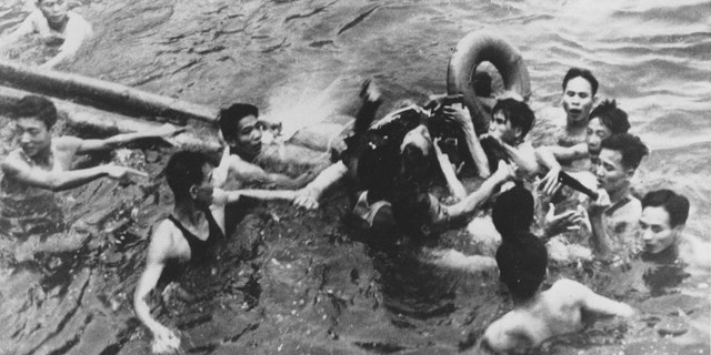 John McCain is pulled out of a Hanoi lake by a mix of North Vietnamese Army (NVA) and Vietnamese citizens in this October, 1967 file photo. McCain was shot down by a Surface-to-Air Missile (SAM) and had broken both arms and his right knee upon ejection, losing consciousness,
