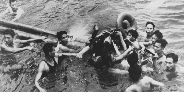 John McCain is pulled out of a Hanoi lake by a mix of North Vietnamese Army (NVA) and Vietnamese citizens in this October, 1967 file photo. McCain was shot down by a Surface-to-Air Missile (SAM) and had broken both arms and his right knee upon ejection, losing consciousness,