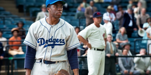 This film image released by Warner Bros. Pictures shows Chadwick Boseman as Jackie Robinson in a scene from "42." Kansas City's Negro Leagues Baseball Museum is hosting an advance screening of an upcoming movie about Jackie Robinson, who broke major league baseball's color barrier. Thomas Butch of the financial firm Waddell and Reed announced Wednesday, March 20, 2013, that actors Harrison Ford and Andre Holland will be among those appearing at an April 11 screening of "42."