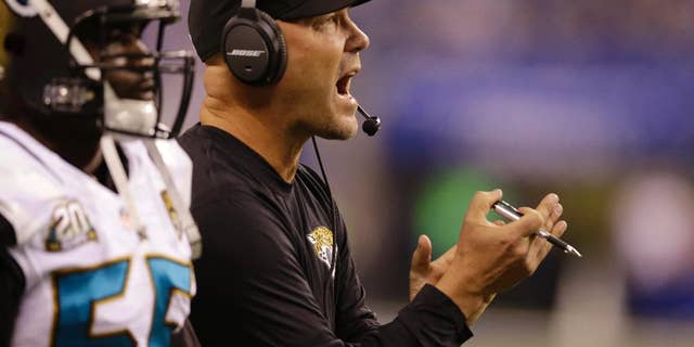 Jacksonville Jaguars head coach Gus Bradley cheers for his team during the first half of an NFL football game against the Indianapolis Colts, Sunday, Nov. 23, 2014, in Indianapolis. (AP Photo/Michael Conroy)