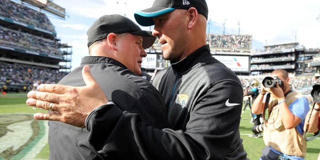Philadelphia Eagles head coach Chip Kelly, left, and Jacksonville Jaguars head coach Gus Bradley meet after an NFL football game, Sunday, Sept. 7, 2014, in Philadelphia. Philadelphia won 34-17. (AP Photo/Michael Perez)