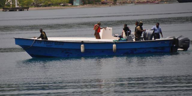 Jamaican Defence Force members return to Port Antonio Marina in Portland, Jamaica, Saturday, Sept. 6, 2014, after a fruitless search for a plane that crashed into the ocean a day earlier. Rescue crews searching off Jamaica's coast on Saturday said they could no longer see debris spotted earlier, stymieing efforts to solve the mystery surrounding a small plane carrying a prominent upstate New York couple that went on a ghostly 1,700-mile journey after the pilot was apparently incapacitated. Jamaican officials said that possible wreckage from the single-engine turboprop Socata TBM700 was sighted Friday evening by a military aircraft flying off the island's northeast coast, drifting roughly 24 miles off the coastal town of Port Antonio. (AP Photo/Everard Owen)