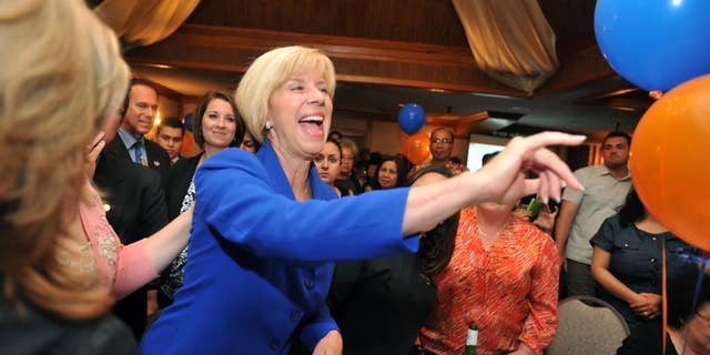 Los Angeles City councilwoman Janice Hahn, running for Congressional District 36th, makes her way through the crowd of supporters Tuesday night July 12, 2011 at her election party. (AP Photo/Sean Hiller - Daily Breeze)
