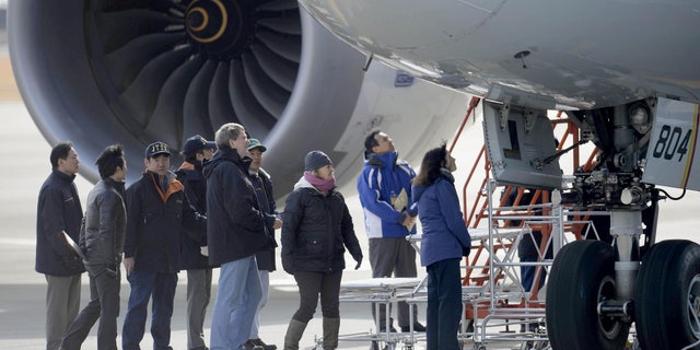 Jan. 18, 2013 - U.S. officials, center, inspect All Nippon Airways jet which made an emergency landing Wednesday, at an airport in Takamatsu, Japan.