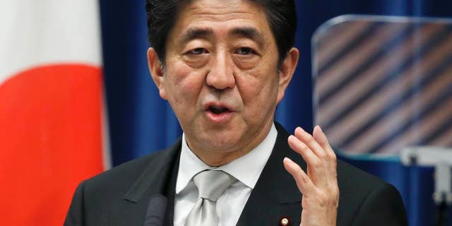FILE - In this Wednesday, Dec. 24, 2014 file photo, Japan's Prime Minister Shinzo Abe speaks during a press conference at his official residence in Tokyo after taking office for a third term as prime minister. Japan's Cabinet approved a record 96.3 trillion yen ($814 billion) government budget for the coming fiscal year Wednesday, Jan. 14, 2015. (AP Photo/Shizuo Kambayashi, File)