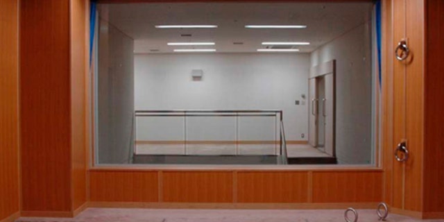 In this photo taken and released on by Japan's Justice Ministry, the trapdoor where a condemned criminal is to stand is marked with a red double square on the floor in an execution room at Tokyo Detention Center when the local media are allowed a rare tour of Tokyo's main gallows in a bid to create more public awareness about capital punishment. Three death row inmates in Japan were executed by hanging on Thursday, March 29, 2012, the country's first executions in more than a year and a half. Japan, along with the United States, is one of the few industrialized countries that still has capital punishment. The room behind the glass window is for witnesses to stand and observe the execution.