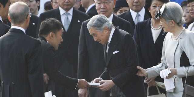 FILE - In this Thursday, Oct. 31, 2013 file photo, actor-turned-lawmaker Taro Yamamoto, second left, hands over a letter to Japan's Emperor Akihito, second right, as Empress Michiko, right, and chief steward Yutaka Kawashima, top center, look on during the autumn garden party at the Imperial Palace in Tokyo. The novice lawmaker has caused an uproar in Japan by doing something taboo: handing a letter to the emperor - a gesture considered both impolite and inappropriate. (AP Photo)