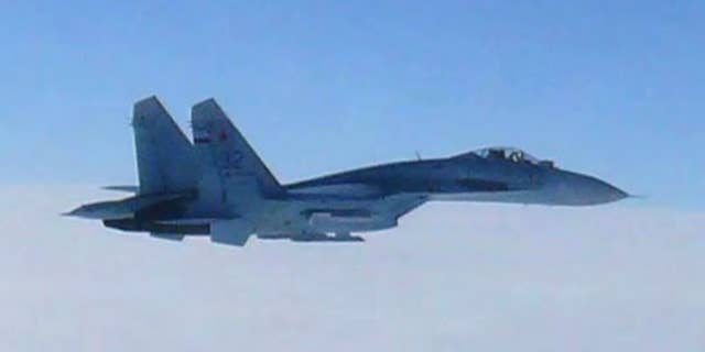 FILE - In this Feb. 7, 2013 file photo taken by Japan Air Self-Defense Force and released by the Joint Staff Office of the Defense Ministry of Japan, Russian fighter jet SU-27 flies over the sea off the Japanese island of Hokkaido when the Defense Ministry said two SU-27 jets, including the one shown in this photo, briefly intruded into Japanese airspace in the afternoon off the coast of Rishiri island on Hokkaido's west coast, prompting Japan’s air force to scramble jets. Japan's government said Wednesday, April 15, 2015 that the number of scrambles by the country's warplanes has surged in recent years to levels nearly matching the Cold War era amid growing activity by China and Russia in the region. (The Joint Staff Office of the Defense Ministry of Japan via AP, File)