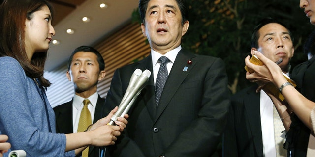 May 29. 2014: Japanese Prime Minister Shinzo Abe, center, speaks to the media about a three-day talks in Stockholm with North Korea at the prime minister's official residence in Tokyo. (AP)