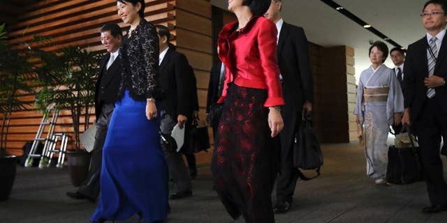 Midori Matsushima, center, newly appointed minister of Justice, Yuko Obuchi, 2nd left, newly appointed minister of Trade and Economy, and Eriko Yamatani, 3rd right, newly appointed minister in charge of abduction issue, leave for the attestation ceremony at the Imperial Palace at the prime minister's official residence in Tokyo Wednesday, Sept. 3, 2014. (AP Photo/Eugene Hoshiko)