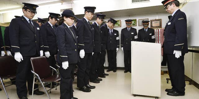 In this 2015 photo, Tokyo subway workers offered silent prayer 20 years after the poison gas attack.