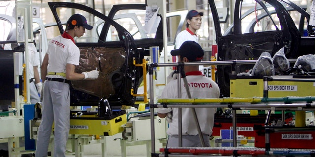 FILE - In this March 15, 2013 file photo, Indonesian workers assemble passenger cars at the new Toyota plant in Karawang, West Java, Indonesia after Toyota officially opened their second manufacturing plant in the country. Toyota is building two new auto plants, one in Mexico and the other in China, ending a three-year hiatus from such ambitions that the Japanese automaker voluntarily imposed on itself after a massive recall scandal. Toyota Motor Corp. announced Wednesday, April 15, 2015 it will invest $1 billion for the plant in Guanajuato, Mexico, creating 2,000 jobs, to make the Corolla subcompact - one of Toyotaâs biggest hits. (AP Photo/Tatan Syuflana, File)
