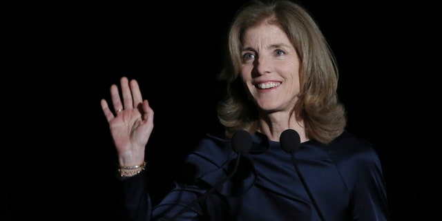March 18, 2015: U.S. Ambassador to Japan Caroline Kennedy waves before she delivers opening remarks during JFK International Symposium at Waseda University in Tokyo. (AP Photo/Eugene Hoshiko)