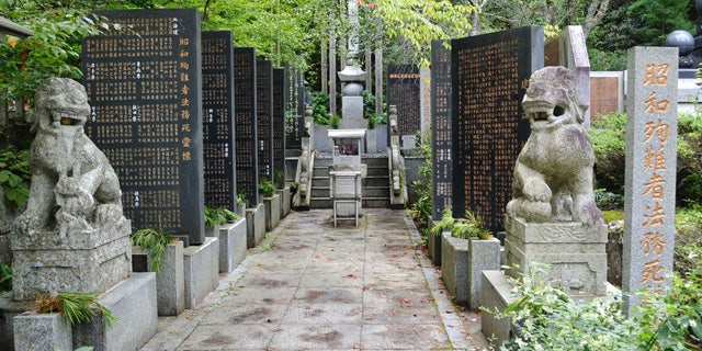 August 27, 2014: Stone-carved guardian dogs sit at the entrance of a memorial compound honoring World War II-era war criminals in Koyasan Okuno-in temple in Koya town, Wakayama prefecture, central Japan. (AP Photo/Kyodo News)