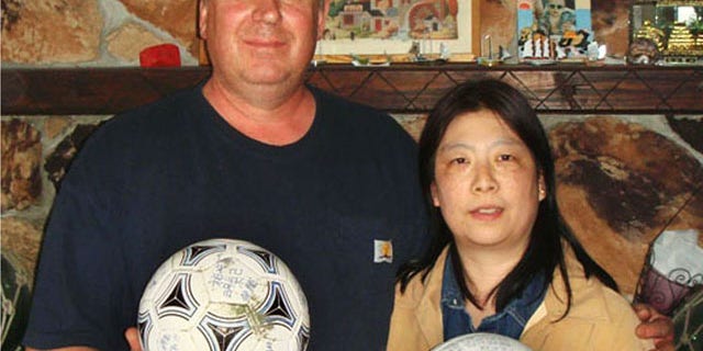 April 21, 2012: David and Yumi Baxter hold a soccer ball and a volleyball which David found, at their house in the suburbs of Anchorage, Alaska