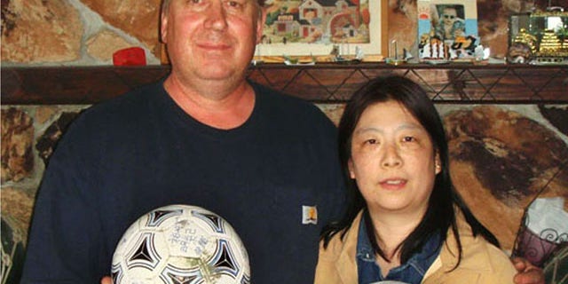 April 21, 2012: David and Yumi Baxter hold a soccer ball and a volleyball which David found, at their house in the suburbs of Anchorage, Alaska
