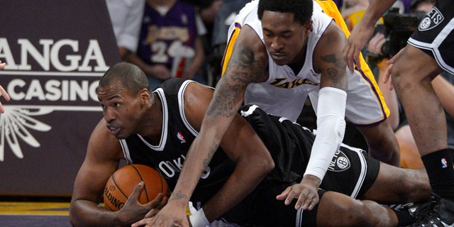 Brooklyn Nets center Jason Collins, left, battles for a loose ball with Los Angeles Lakers guard MarShon Brooks during the first half of an NBA basketball game, Sunday, Feb. 23, 2014, in Los Angeles. (AP Photo/Mark J. Terrill)
