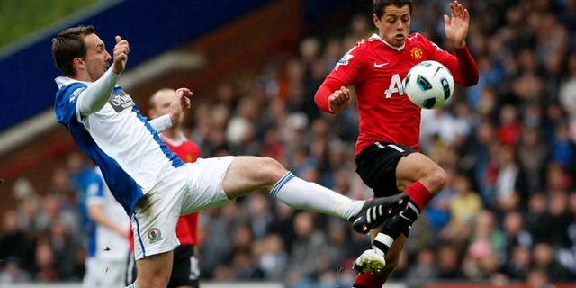 Manchester United's Javier Hernandez, right, vies for the ball against Blackburn's Gael Givet during their English Premier League soccer match at Ewood Park, Blackburn, England, Saturday May 14, 2011. (AP Photo/Tim Hales) NO INTERNET/MOBILE USAGE WITHOUT FOOTBALL ASSOCIATION PREMIER LEAGUE (FAPL) LICENCE. CALL +44 (0) 20 7864 9121 or EMAIL info@football-dataco.com FOR DETAILS