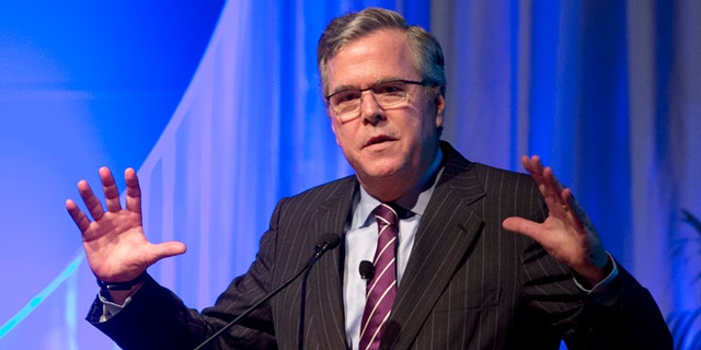 This Jan. 29, 2014 photo, former Florida Gov. Jeb Bush gestures as he speaks at the Inside ITFs Conference at the Westin Diplomat Resort &amp; Spa in Hollywood, Fla.  Bush says heâs all the speculation about whether heâll run for president in 2016 is actually getting him more attention than if he had already entered the race. The former Republican governor of Florida says thatâs not by design, and that heâll make his decision before yearâs end. He tells Fox News Channel that the state of politics is ``crazy right now.â (AP Photo/Wilfredo Lee)