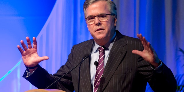 This Jan. 29, 2014 photo, former Florida Gov. Jeb Bush gestures as he speaks at the Inside ITFs Conference at the Westin Diplomat Resort & Spa in Hollywood, Fla. Bush says heâs all the speculation about whether heâll run for president in 2016 is actually getting him more attention than if he had already entered the race. The former Republican governor of Florida says thatâs not by design, and that heâll make his decision before yearâs end. He tells Fox News Channel that the state of politics is ``crazy right now.â (AP Photo/Wilfredo Lee)