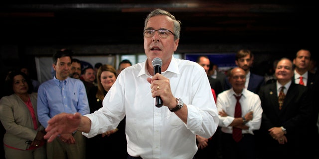 FILE - In this April 28, 2015 file photo, former Florida Gov. Jeb Bush speaks during a town hall meeting with Puerto Rico's Republican Party in Bayamon, Puerto Rico. Bush on Wednesday declared that 11 million immigrants in the country illegally should have an opportunity to stay, wading into the explosive immigration debate for the second time in two days while courting Hispanic voters. (AP Photo/Ricardo Arduengo, File)