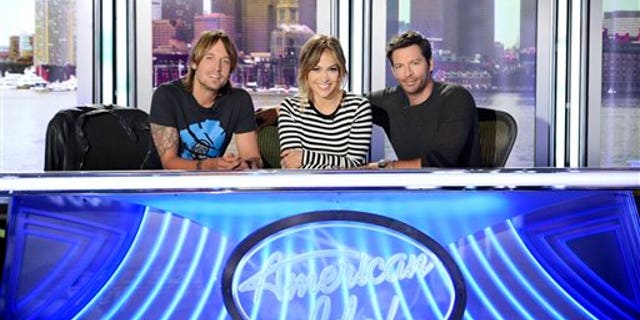 FILE - This 2013 file publicity photo released by FOX shows American Idol XIII judges, from left, Keith Urban, Jennifer Lopez and Harry Connick Jr. One thing about season 13 of "American Idol" is that unlike last season, the judges seem to be getting along. (AP Photo/FOX, Michael Becker)