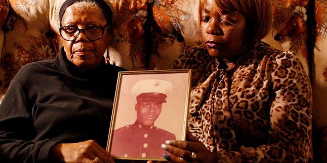March 12, 2014: Alma Murdough and her daughter Cheryl Warner hold a photo of Murdough's son, at her home in the Queens borough of New York.