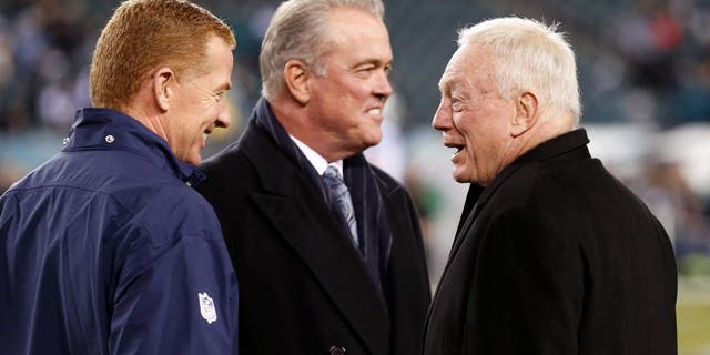 Dec 14, 2014; Philadelphia, PA, USA; Dallas Cowboys head coach Jason Garrett (left) and owner Jerry Jones (right) talk during warm ups before a game against the Philadelphia Eagles at Lincoln Financial Field. Mandatory Credit: Bill Streicher-USA TODAY Sports