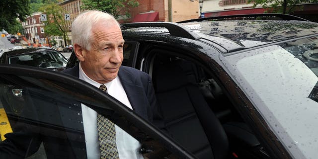 In a Tuesday, May 29, 2012 file photo, Jerry Sandusky gets into his attorney Joe Amendola's car near the Centre County Courthouse Annex in Bellefonte, Pa.