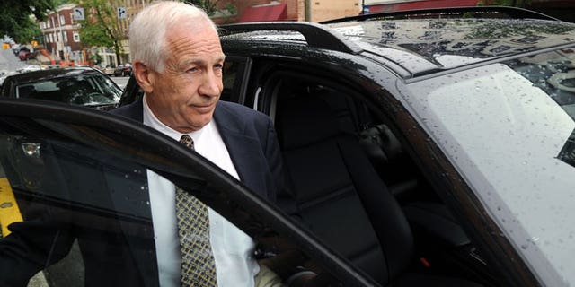In a Tuesday, May 29, 2012 file photo, Jerry Sandusky gets into his attorney Joe Amendola's car near the Centre County Courthouse Annex in Bellefonte, Pa.