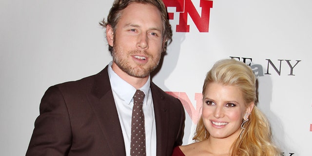 Nov. 29, 2011: In this file photo, singer Jessica Simpson, right, poses with Eric Johnson at the 25th Annual Footwear News Achievement Awards at The Museum of Modern Art in New York.