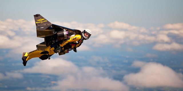 July 29, 2013: Swiss adventurer Yves Rossy, also known as "Jetman," flies in his carbon-Kevlar jetwing with four engines for during an event for reporters over Appleton, Wis.