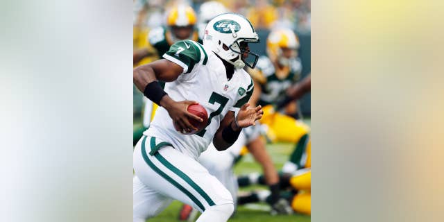Green Bay Packers' Aaron Rodgers celebrates after throwing a touchdown pass during the second half of an NFL football game against the New York Jets Sunday, Sept. 14, 2014, in Green Bay, Wis. (AP Photo/Tom Lynn)