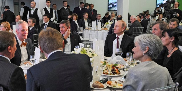 Russian President Vladimir Putin, center right, with retired U.S. Lt. Gen. Michael T. Flynn, center left, and former Green Party presidential candidate Jill Stein, front right, attend a 2015 dinner in Moscow. 