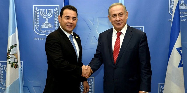 Guatemalan President Jimmy Morales and Israeli Prime Minister Benjamin Netanyahu shake hands at the opening of the Central American nation's embassy in Jerusalem.