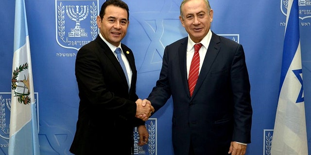 Guatemalan President Jimmy Morales and Israeli Prime Minister Benjamin Netanyahu shake hands at the opening of the Central American nation's embassy in Jerusalem.