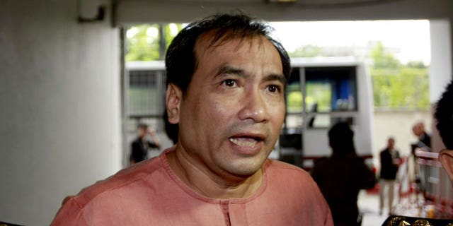 October 10, 2011: Joe Gordon, a Thai-born American, speaks to reporters upon his arrival at criminal court in Bangkok.