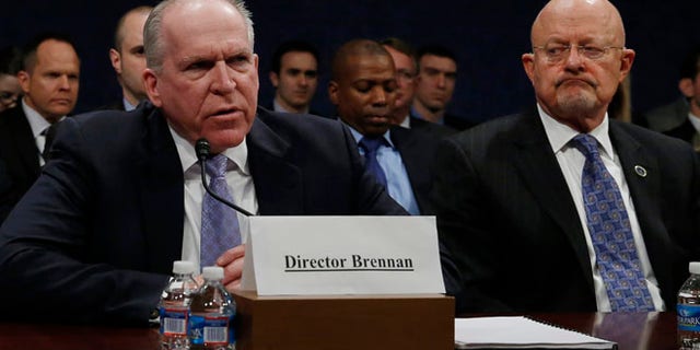 Director of U.S. National Intelligence James Clapper (R) listens to CIA Director John Brennan (L) during testimony at the House Intelligence Committee on 'Worldwide Threats', in Washington February 4, 2014.