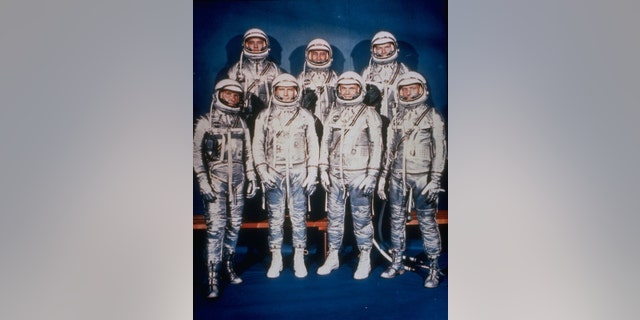This 1961 file photo provided by NASA shows the original seven Mercury astronauts in their silver spacesuits. First row, from left are Walter Schirra Jr., Donald Slayton, John Glenn and Scott Carpenter. In the back row are Alan Shepard, Jr., Virgil Grissom and Gordon Cooper.