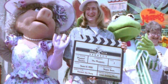 FILE - Puppeteer John Henson, the son of the late Muppets creator Jim Henson is seen with Muppets Miss Piggy and Kermit at the Disney/MGM studios in Lake Buena Vista, Florida in this June 15, 1990 file photo. Cheryl Henson says her brother died of a "massive heart attack" died at his home in Saugerties, New York on Friday Feb. 14, 2014. He was 48. (AP Photo/FILE)